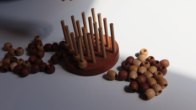 logic wooden board game and a boy playing with it close-up