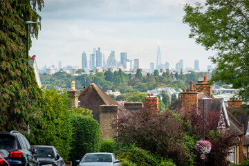 LONDON- Street of house rooftops in Wimbledon with view of the City of London- south west London -...