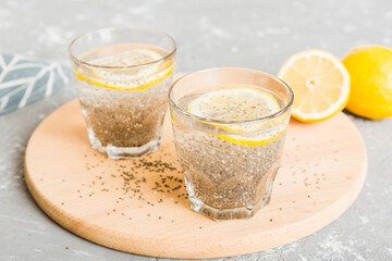 Healthy breakfast or morning with chia seeds and lemon on table background, vegetarian food, diet and health concept. Chia pudding with lemon
