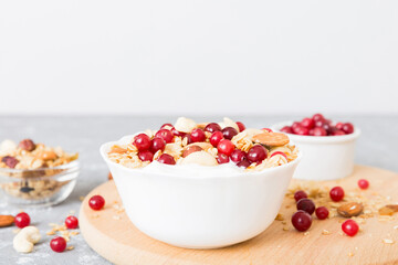 Healthy breakfast food with granola, yogurt, fruits and nuts. Dessert parfait with dried fruits for breakfast