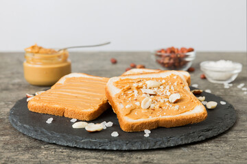 Peanut butter sandwiches or toasts on light table background.Breakfast. Vegetarian food. American cuisine top view vith copy space