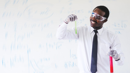 African scientists are conducting experiments on chemicals for medical use while wearing safety gloves and goggles.