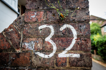 The Number 32 written on a old brick wall