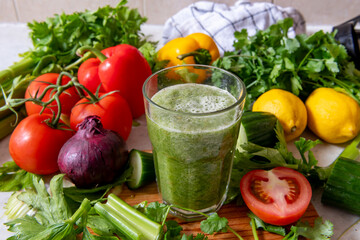 A glass of smoothie made with a blend of healthy raw vegetables. Healthy lifestyle and living concept.
