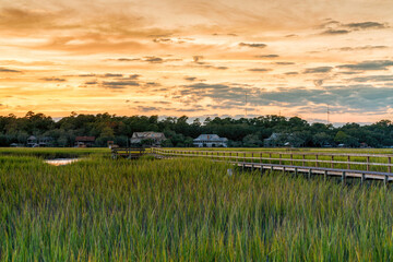 wooden dock on the inlet at Pawleys Island in South Carolina in warm golden light at sunset