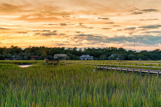 wooden dock on the inlet at Pawleys Island in South Carolina in warm golden light at sunset
