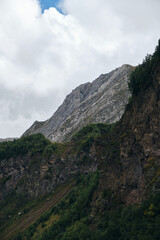 The gorge of the Truso Valley. Beautiful sheer cliffs and mountain peaks with green fields and forest. Amazing nature of mountainous Georgia, Kazbegi region. Beautiful landscape of the national park.