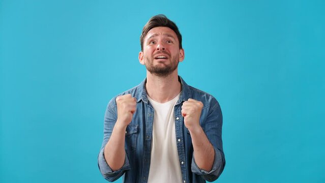 Upset man pleads making prayer gesture and crossing fingers