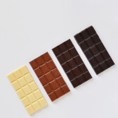 Handmade Chocolate Bars Composition on Light Background