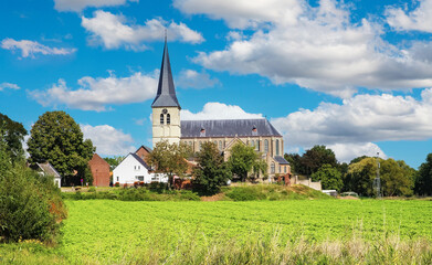Fototapeta na wymiar Beautiful belgian countryside landscape with rural village and church tower - Kessenich, Belgium