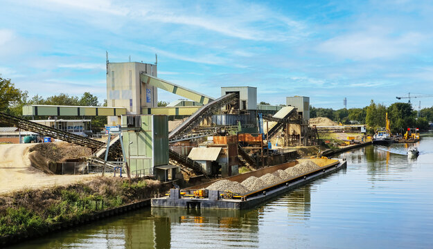 Wessem (NSI Holland B.V.), Netherlands - September 9. 2023: Sand and gravel plant at river Maas with cargo ship