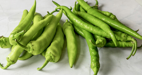 A bunch of green pepper pods. Hot chili pepper.
