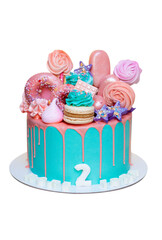 Birthday cake with turquoise frosting and pink birthday decorations ready for a birthday party,...