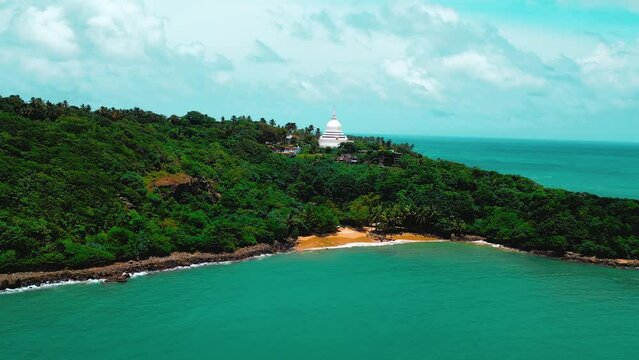 Drone hovering Ocean to jungle-fringed beach. Ideal for travel, nature, and adventure content. Aerial views of stunning beauty