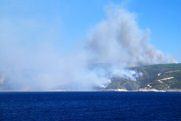 Fototapeta premium wildfire on greek island seen from ferryboat