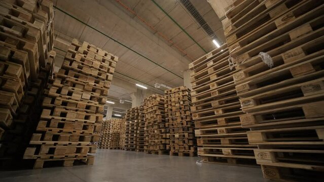 Stack of wooden pallets rack at warehouse storage.