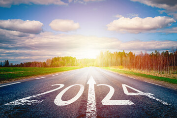 New year 2024 or straightforward concept. Text 2024 written on the road of asphalt road at sunset.Concept of planning and challenge, business strategy, opportunity ,hope, new life change.