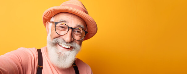 Portrait of smiling elderly man in modern minimalist style against apricot crush background. Copy space. Banner - obrazy, fototapety, plakaty
