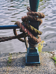 Boat rope by a canal of Amsterdam. - obrazy, fototapety, plakaty