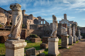 Statues of virgin vestals and ruins of Maxentius Basilica on the Roman Forum in Rome, Italy