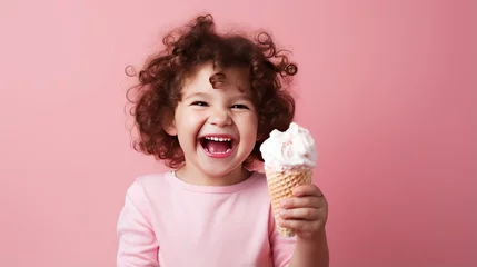Poster Cheerful little girl with curly hair eating ice cream on pink background © Анастасия Козырева
