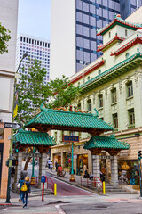 San Francisco elaborate Chinatown entrance with pedestrians and shops