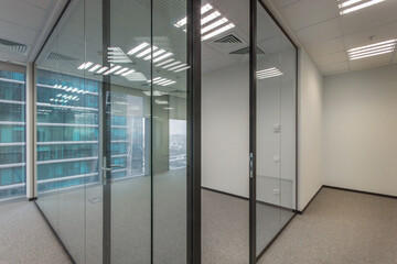 Cubicle office with glass walls and panoramic windows.