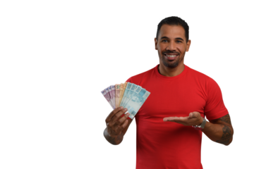 smiling man points to the money in his hand, Brazilian money, wearing a red t-shirt