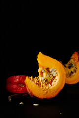 Slices of pumpkin on a black background.