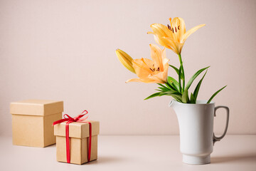 Orange lily flowers and gift box.