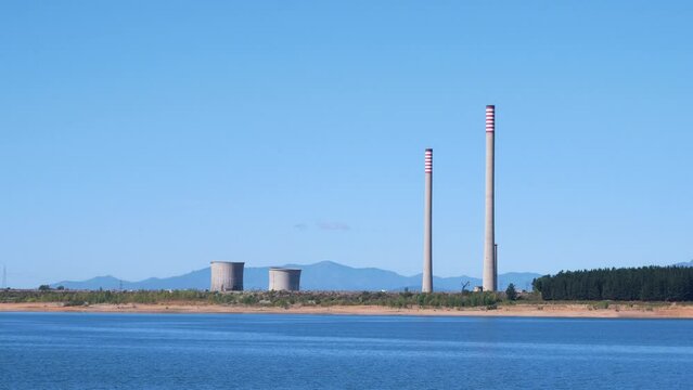 Demolition of the cooling towers and a chimney of the Compostilla II thermal power plant creating a large cloud of dust around them erasing the symbol of its industrial past from the Bercian landscape