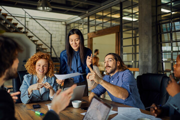 Young and diverse group of designers having a meeting in an office while working in a startup company