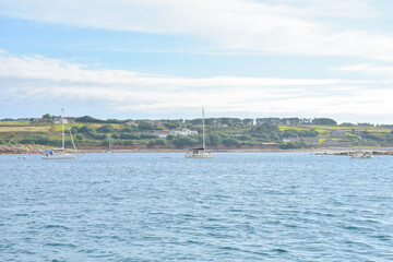 Fototapeta premium View to pier and coast, dramatic sky, isles of Scilly, United Kingdom