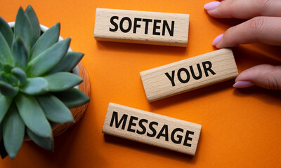 Soften your Message symbol. Concept words Soften your Message on wooden blocks. Beautiful orange background with succulent plant. Businessman hand. Business concept. Copy space.