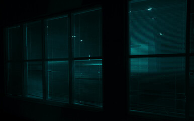 Lights and Shadows - Blinds. Venetian blind in front of window in illuminated room. Exterior view. night scene.