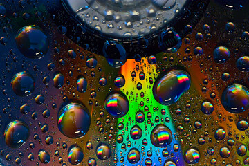 Dark rainbow burst inside fizzy bubbles floating across colorful metallic surface