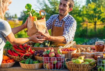 Man and woman at a farmers market. Selective focus.