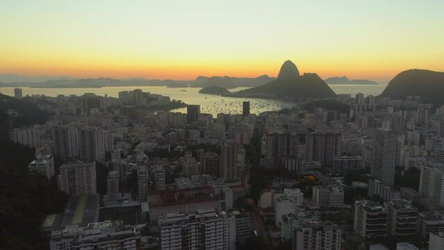 Sunrise aerial of Rio de Janeiro Sugarloaf Mountain Copacabana with Guanabara Bay in the background high rise apartment blocks in the foreground