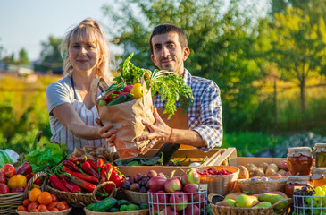 Man and woman at a farmers market. Selective focus.