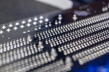 Motherboard backside close-up with pins, desktop PC. Computer technology hardware components...