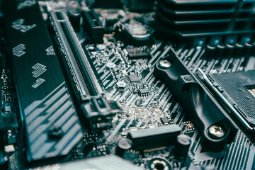 Motherboard with sockets and microchips close-up on modern powerful desktop PC. Computer hardware...