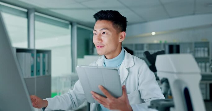 Scientist, tablet and computer for research, data analysis and typing test results or laboratory report. Doctor, science expert or happy asian man with medical or digital software for biotechnology