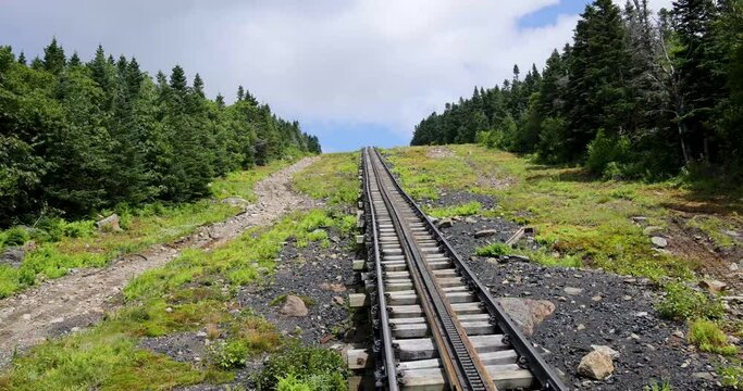 A cog railway train going up a steep part on mount Washington on the first part of the track