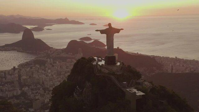 Aerial shot of Christ the Redeemer statue on Corcovado mountain and Rio de Janeiro cityscape at sunset in Brazil, South America