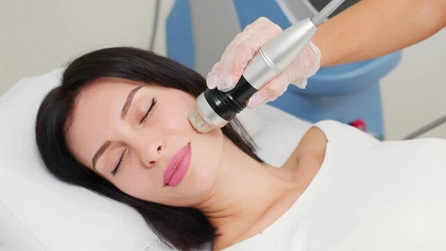 Micro-Needle RF Lifting Neck Skin. Caucasian female getting RF lifting procedure of face and neck area at cosmetology clinic. Professional skincare, beauty treatment 