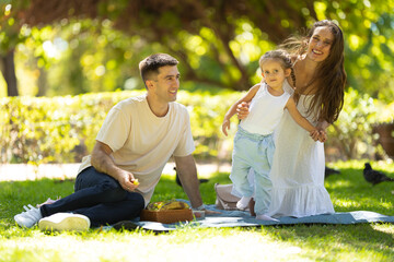 Family having a picnic and having fun in the park