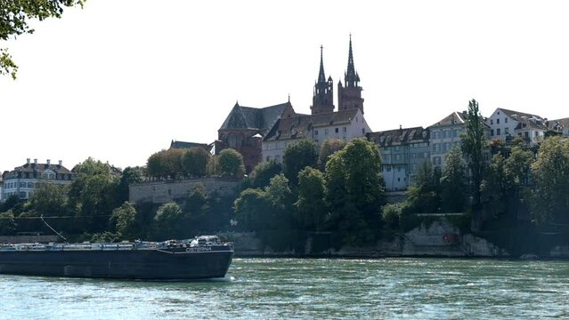 Basler Muenster with the Rhein at summer, The Rhine River flowing past some historical buildings in Basel, Switzerland.