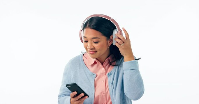 Phone, music and question with a confused asian woman isolated on white background in studio to ask what. Portrait, doubt and young person looking annoyed while listening to sound or streaming audio