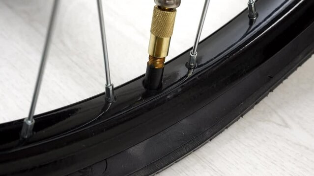 4K - Bicycle wheel inflation. Close-up