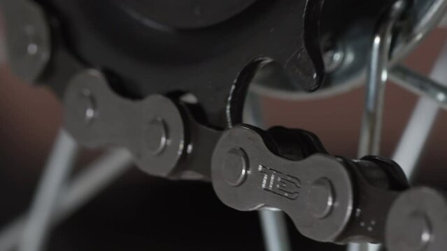 4K - Bicycle chain with gears in motion. Close-up